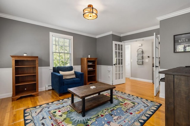 67 Madison St, Amesbury, MA 01913 - living area featuring a baseboard radiator, wood finished floors, ornamental molding, and french doors