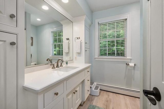 67 Madison St, Amesbury, MA 01913 - bathroom with a baseboard heating unit, vanity, wood finished floors, and recessed lighting