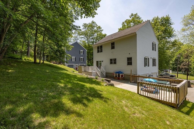 67 Madison St, Amesbury, MA 01913 - back of house with a deck, a lawn, and an attached garage