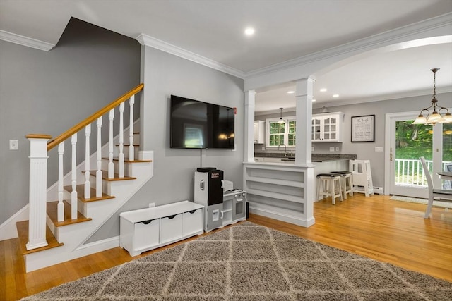 67 Madison St, Amesbury, MA 01913 - living room with crown molding, light wood-style flooring, stairway, recessed lighting, and arched walkways
