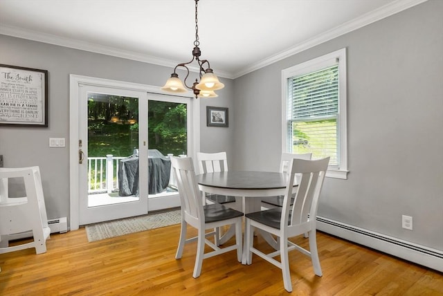 67 Madison St, Amesbury, MA 01913 - dining room with baseboard heating, a chandelier, light wood-style floors, and ornamental molding