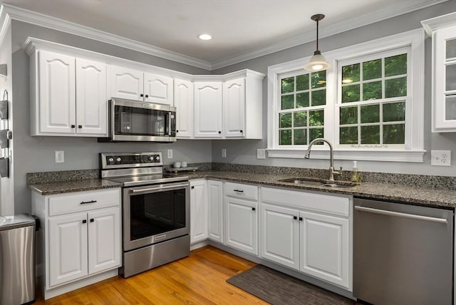 67 Madison St, Amesbury, MA 01913 - kitchen with appliances with stainless steel finishes, white cabinetry, light wood finished floors, decorative light fixtures, and crown molding