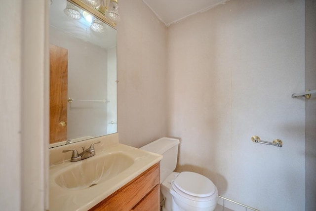 half bath featuring toilet and vanity