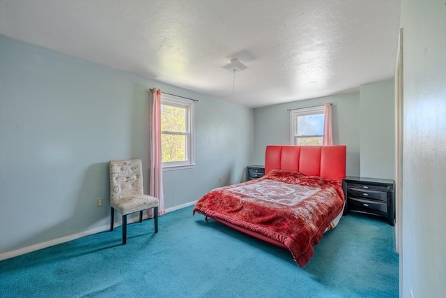carpeted bedroom featuring baseboards