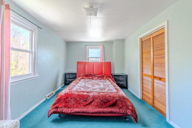 carpeted bedroom with multiple windows and baseboards