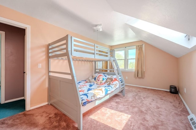 bedroom with carpet, lofted ceiling, baseboards, and a skylight