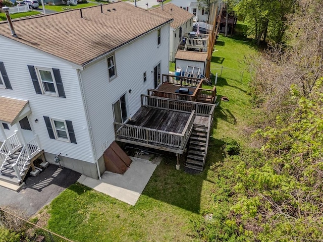 back of house featuring a wooden deck, stairway, a lawn, and a patio area