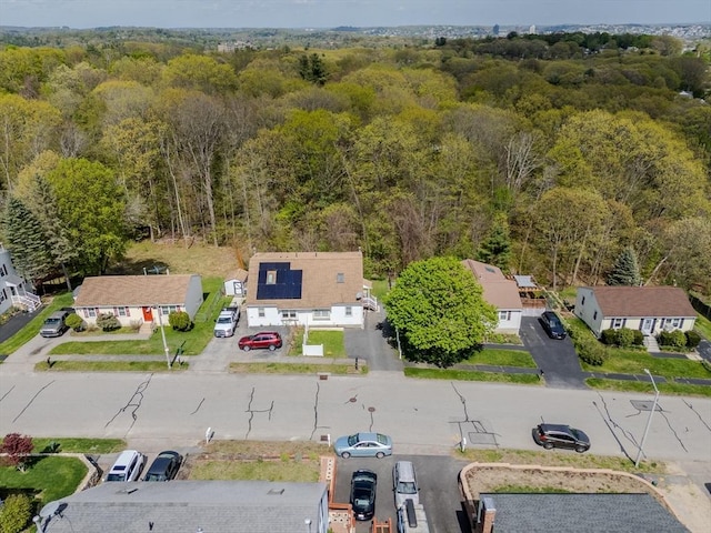 aerial perspective of suburban area with a heavily wooded area