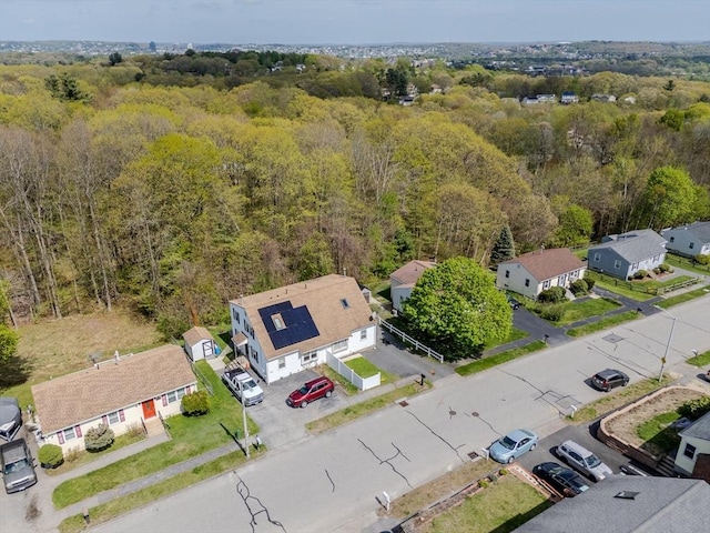 aerial view of residential area with a heavily wooded area