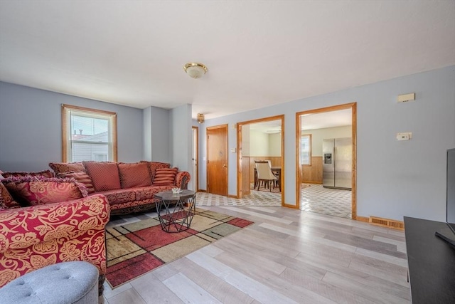 living area featuring light wood finished floors and baseboards