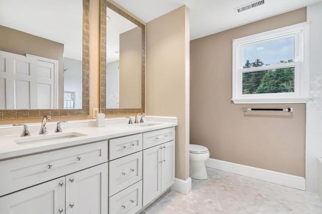 72 Rinnock Rd, Fitchburg, MA 01420 - bathroom featuring double vanity, toilet, and baseboards