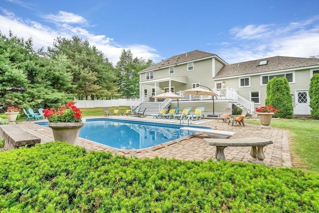 view of pool with a patio area, a diving board, and a wooden deck