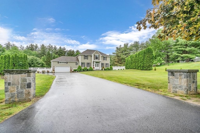 view of front of house featuring a garage and a front lawn