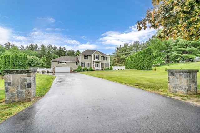 view of front of house with a front lawn and a garage