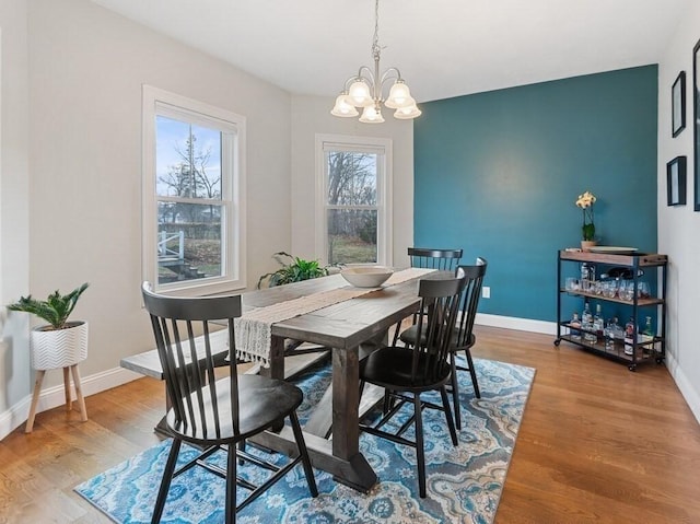 38 Oneil St, Hudson, MA 01749 - dining room featuring a chandelier, wood finished floors, and baseboards