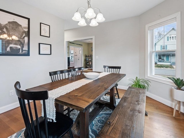 38 Oneil St, Hudson, MA 01749 - dining room with a chandelier, wood finished floors, and baseboards
