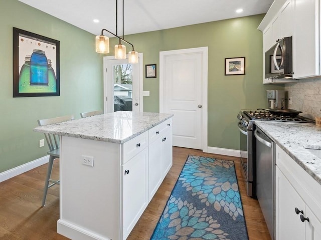 38 Oneil St, Hudson, MA 01749 - kitchen featuring stainless steel appliances, dark wood-style flooring, a center island, baseboards, and recessed lighting