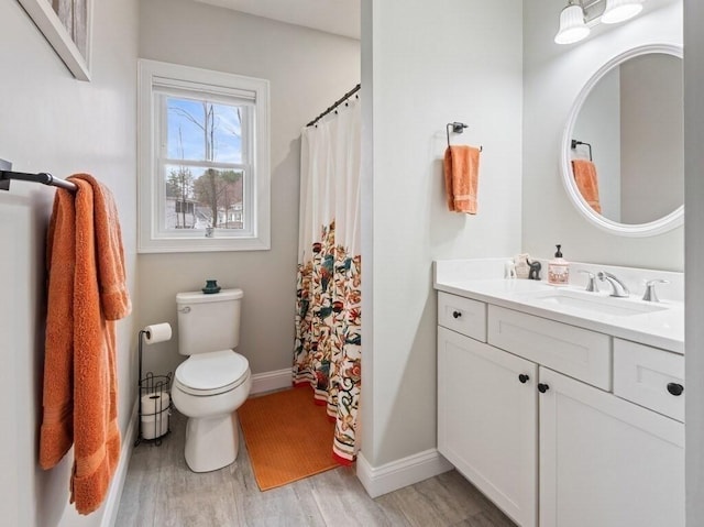 38 Oneil St, Hudson, MA 01749 - full bath featuring wood finished floors, vanity, toilet, baseboards, and a shower with shower curtain