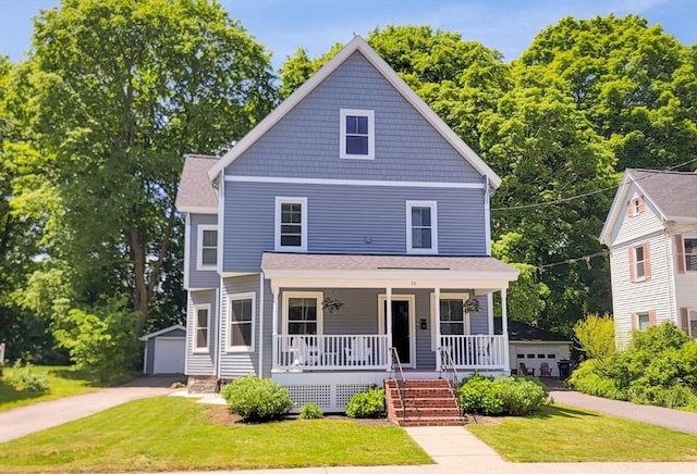 38 Oneil St, Hudson, MA 01749 - american foursquare style home featuring covered porch, a detached garage, a front yard, and an outbuilding