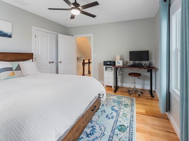 38 Oneil St, Hudson, MA 01749 - bedroom with light wood finished floors, baseboards, ceiling fan, and a closet