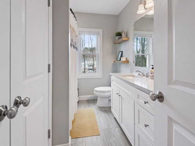 38 Oneil St, Hudson, MA 01749 - full bath featuring toilet, vanity, baseboards, and wood finished floors