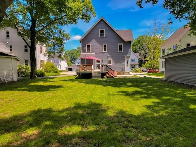 38 Oneil St, Hudson, MA 01749 - rear view of property featuring a wooden deck and a lawn