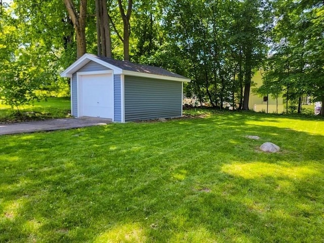 38 Oneil St, Hudson, MA 01749 - view of grassy yard with an outbuilding, a detached garage, and driveway
