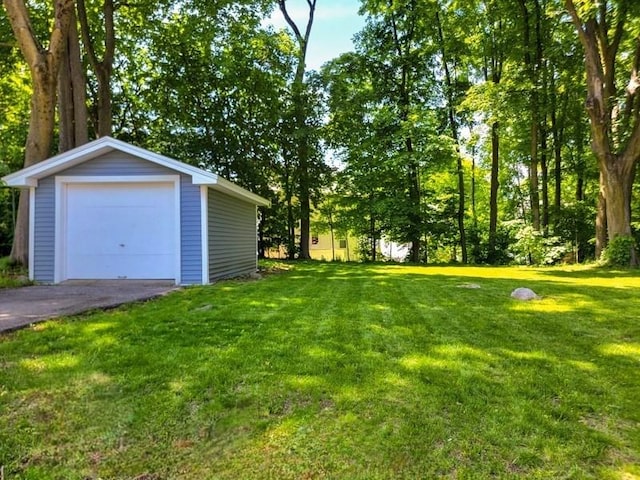 38 Oneil St, Hudson, MA 01749 - view of grassy yard with an outdoor structure, a detached garage, and driveway