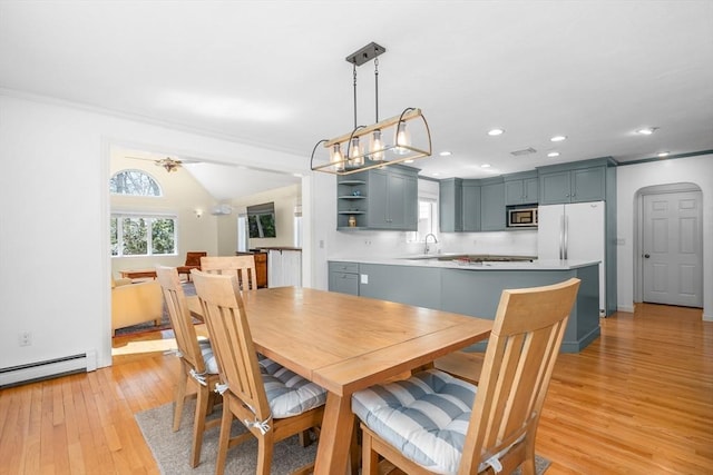 dining area featuring crown molding, recessed lighting, and light wood-type flooring
