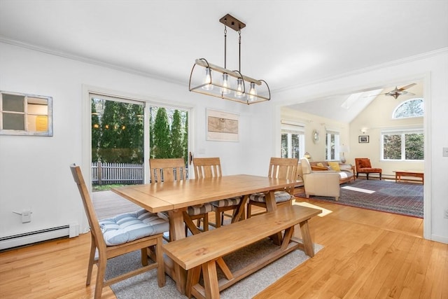 dining area featuring a healthy amount of sunlight, light wood-style floors, and vaulted ceiling