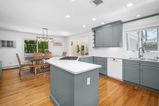 kitchen with visible vents, gray cabinets, a sink, dishwasher, and stainless steel gas stovetop