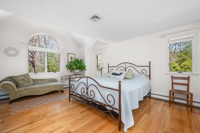 bedroom with visible vents, light wood-style flooring, and multiple windows