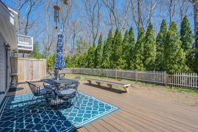 deck featuring a fenced backyard and outdoor dining space