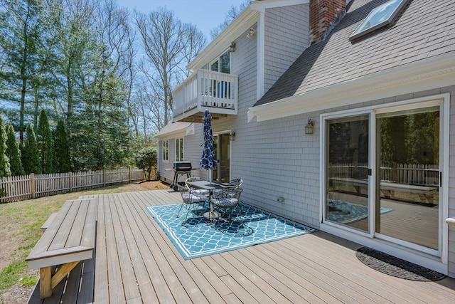 wooden terrace with fence and grilling area