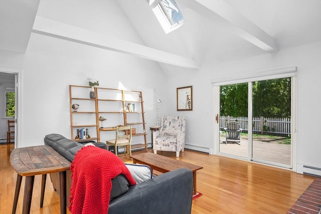 living area featuring plenty of natural light, wood finished floors, baseboard heating, and high vaulted ceiling