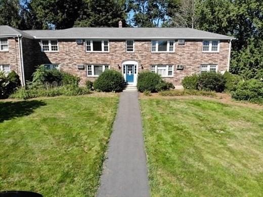 view of front of house with a chimney and a front yard