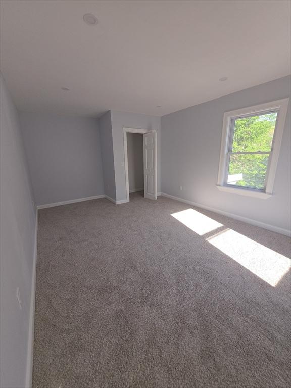 unfurnished bedroom with light carpet and baseboards