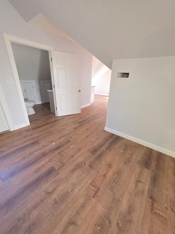 bonus room featuring lofted ceiling, wood finished floors, and baseboards