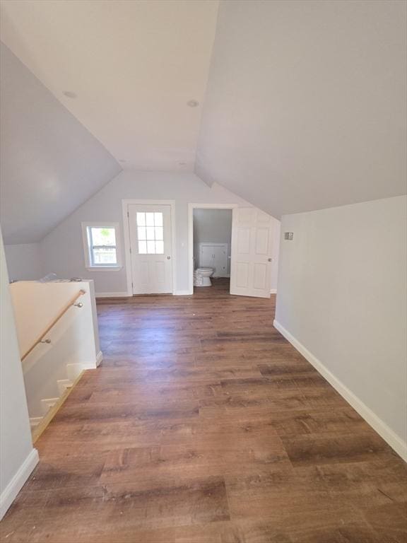 additional living space with baseboards, wood finished floors, and lofted ceiling