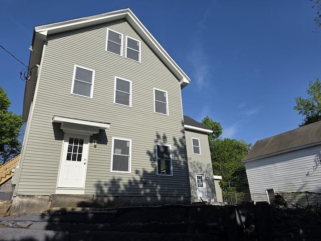 rear view of house featuring entry steps