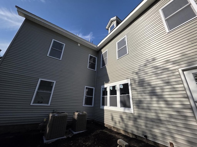 back of property featuring central air condition unit