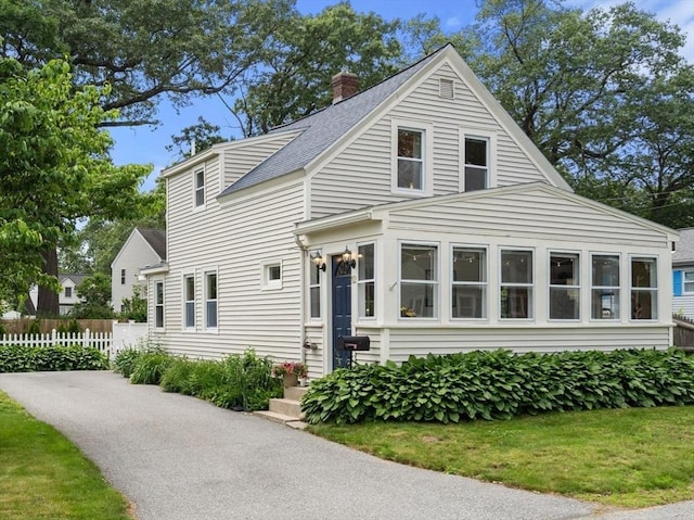 12 Fern St, Chelmsford, MA 01824 - view of front facade featuring a chimney and a shingled roof