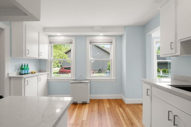 12 Fern St, Chelmsford, MA 01824 - kitchen with light wood-type flooring, white cabinets, light stone countertops, and recessed lighting