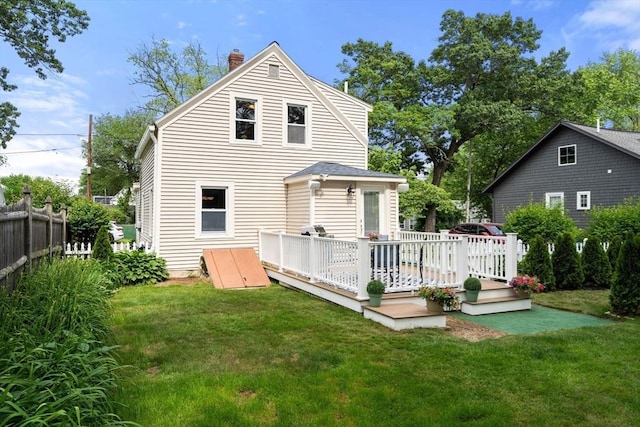 12 Fern St, Chelmsford, MA 01824 - rear view of property featuring a wooden deck and a chimney