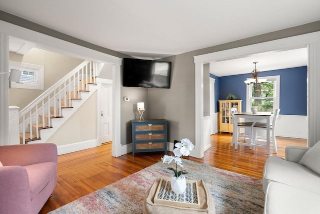 12 Fern St, Chelmsford, MA 01824 - living area with stairway, a chandelier, and wood finished floors