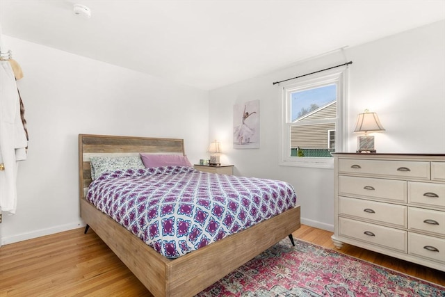 bedroom featuring light wood-style floors and baseboards