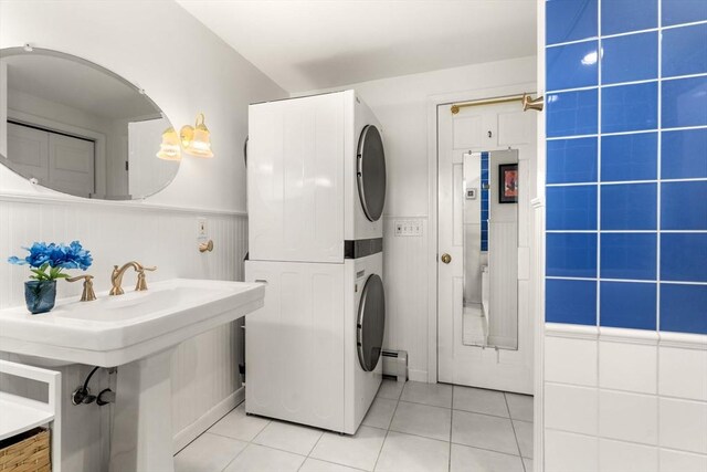 14 Melinda Ln, Easthampton, MA 01027 - clothes washing area featuring light tile patterned flooring, laundry area, wainscoting, stacked washer / dryer, and a baseboard heating unit