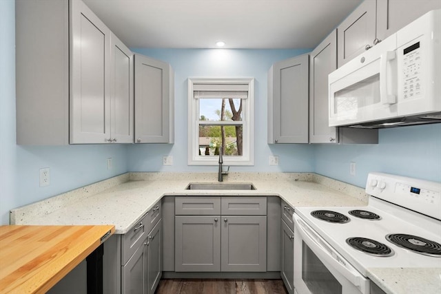 14 Melinda Ln, Easthampton, MA 01027 - kitchen with gray cabinets, light stone countertops, a sink, recessed lighting, and white appliances