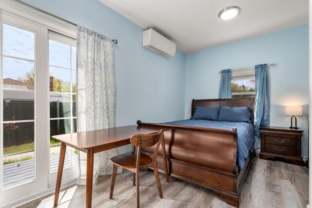 14 Melinda Ln, Easthampton, MA 01027 - bedroom featuring a wall mounted AC and wood finished floors