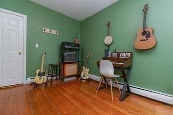 office area with baseboards and wood finished floors